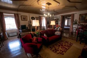 a living room with a red couch and chairs at Solar dos Carvalhos in Sernancelhe +48 photos
