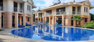 a large swimming pool in front of a building at The Wind Sycamore Holiday Villas in Belek in Belek