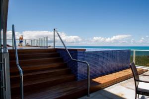 a man walking down the stairs of a house at Silverton Paiva Experience - Flat in Recife