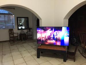 a flat screen tv sitting on a table in a living room at varesse house in Mar del Plata