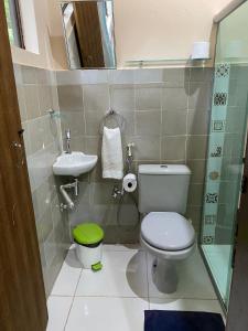 a small bathroom with a toilet and a sink at Solar das Mangueiras - Vale do Capão in Vale do Capao +28 photos