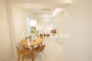 a dining room table with a white tablecloth at White Linen House in Seoul