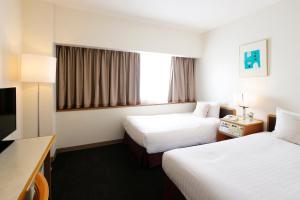 Tempat tidur dalam kamar di Hotel Resol Sasebo