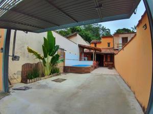 an outside view of a house with a patio at Casa do Loriba com Piscina - 700 metros da praia in São Sebastião