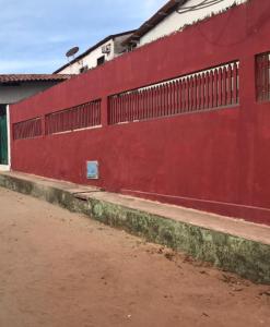 
a red brick building with a red door at Casa Jeri in Jericoacoara

