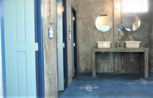 a bathroom with two sinks and a mirror at Chanchalay Hip Hostel SHA Extra Plus in Krabi