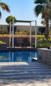 a swimming pool with a pergola next to a swimming pool at One Bedroom Apartment DAMAC Celestia -EXPO Road in Dubai