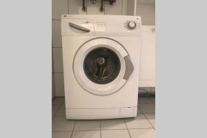 a washer and dryer in a white room at Trade fair and business apartment - Hannover Messe in Hannover