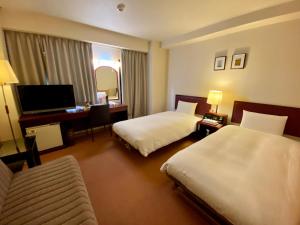 Ένα ή περισσότερα κρεβάτια σε δωμάτιο στο Smile Hotel Sasebo +21 φωτογραφίες