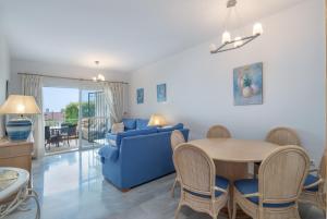 sala de estar con sofá azul y mesa en Apartment Miraflores, en Mijas Costa