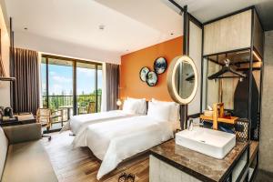 a hotel room with two beds and a sink at The Botanica Sanctuary in Puncak +37 photos