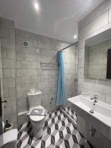 a bathroom with a toilet and a sink at Mironi & Victoria Hotel in Limenas