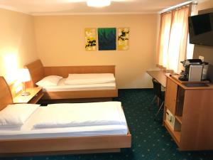Postelja oz. postelje v sobi nastanitve Hotel Gasthof Fischer