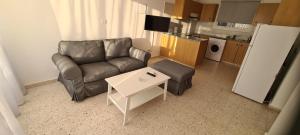 a living room with a couch and a coffee table at Latchi Area Apartments in Lachi