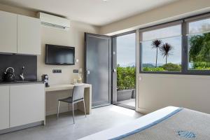a bedroom with a bed and a desk and a window at FeelFree STAYS Basoa in Donostia-San Sebastián