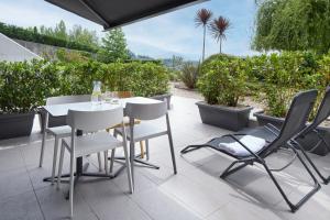 a table and chairs on a patio with plants at FeelFree STAYS Basoa in Donostia-San Sebastián