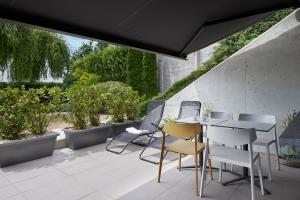 a table and chairs on a patio with plants at FeelFree STAYS Basoa in Donostia-San Sebastián
