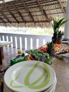 a table with a plate of food on top of it at Standard Queen Room two beds in Puerto Escondido
