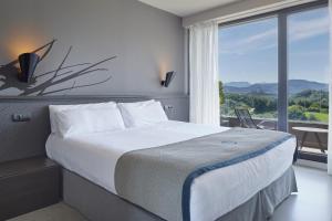 מיטה או מיטות בחדר ב-Irenaz Resort Apartamentos