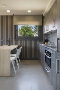 a kitchen with a table and a window in it at FeelFree STAYS Basoa in Donostia-San Sebastián