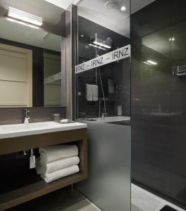 a bathroom with a shower and a sink and a mirror at FeelFree STAYS Basoa in Donostia-San Sebastián