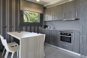 a kitchen with gray cabinets and a white counter top at FeelFree STAYS Basoa in Donostia-San Sebastián