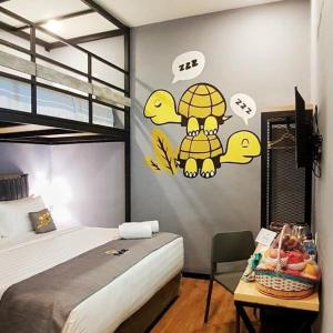 a bedroom with a bed and a table with a tableablish at Nine Hotel in Palembang