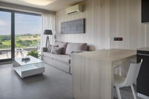 a living room with a couch and a table at FeelFree STAYS Basoa in Donostia-San Sebastián