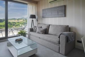 a living room with a couch and a glass table at FeelFree STAYS Basoa in Donostia-San Sebastián