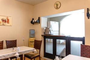 a dining room with a table and a mirror at Boutique hotel Persona in Novokuznetsk