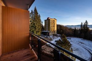 a balcony of a building with snow on the ground at Apartmány ABIES - Štrbské Pleso in Štrbské Pleso