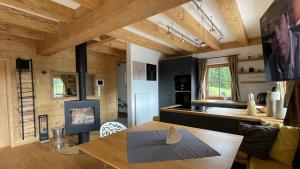 a kitchen and living room with a wooden ceiling at Mankerl Hütte Lachtal in Lachtal