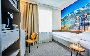 מיטה או מיטות בחדר ב-Hotel Zur Post Altötting
