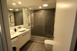 a bathroom with a toilet, sink, and shower at Peregian Court Resort in Peregian Beach