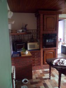 a kitchen with a stove and a microwave at chez gourbeix in Arpheuilles-Saint-Priest