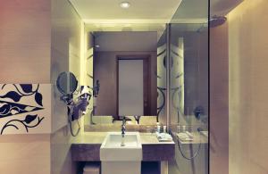 a bathroom with a sink and a mirror at Mercure Jakarta Sabang in Jakarta