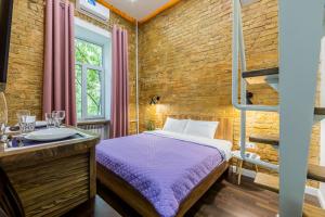 a bedroom with a bunk bed and a bathroom with a sink at Kyiv Brown Loft in Kyiv
