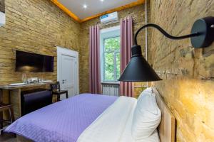 a bedroom with a purple bed and a desk at Kyiv Brown Loft in Kyiv