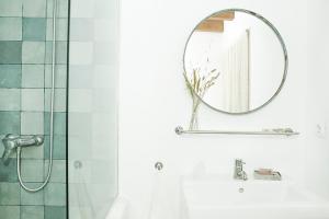 a bathroom with a shower and a mirror at RuralCaMomo in Cádiz