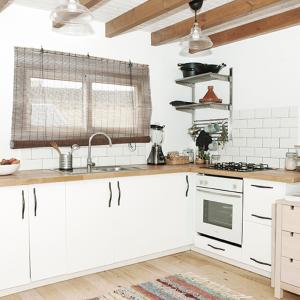 a kitchen with white cabinets and a kitchen sink at RuralCaMomo in Cádiz