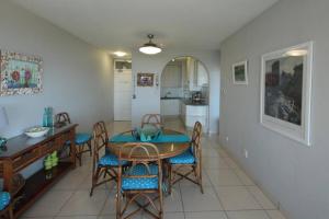 a kitchen and dining room with a table and chairs at SEALODGE 23 UMHLANGA BEACHFRONT in Durban