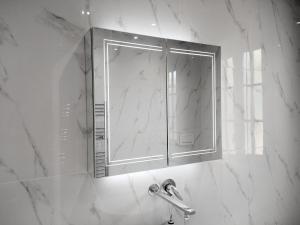 a bathroom with a shower with a mirror and a sink at La Casa in Villaggio Tedeschi