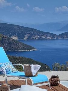 a couple of chairs sitting on a deck with a view of the water at KOTSERIS LUXURY VILLAS, Jiovanni Villa & Angelina Villa in Sivota
