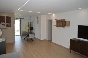 a living room with a table and a dining room at Villa Baia dei Gruccioni in Trani