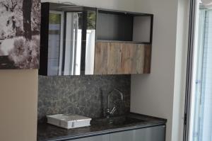 a kitchen with a sink and a mirror at Villa Baia dei Gruccioni in Trani +70 photos