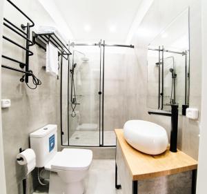 a bathroom with a toilet and a shower at Hi Астана in Astana