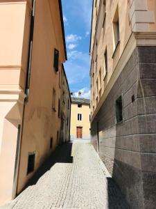 an alley between two buildings in a city at Centrally Located Apartment in Poschiavo in Poschiavo