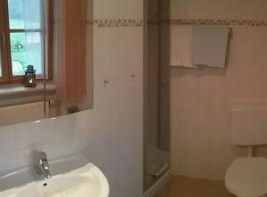 a bathroom with a sink and a toilet at Schusterbauer - Chiemgau Karte in Inzell +16 photos