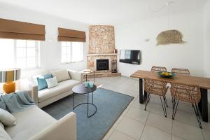 a living room with a couch and a table at Casa Concha by Sevencollection in Carvoeiro