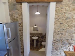 a bathroom with a stone wall and a sink at Fattoria Ceragioli in Camaiore +80 photos